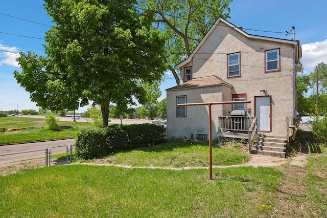 1264 Snelling Ave N, Saint Paul, MN 55108 - rear view of house featuring stucco siding and a wooden deck