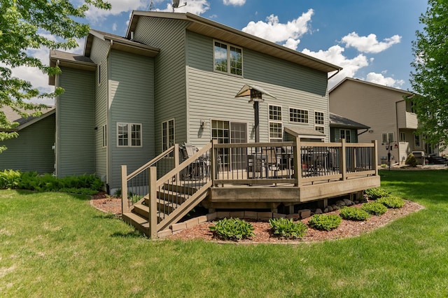 back of property with a yard and a wooden deck