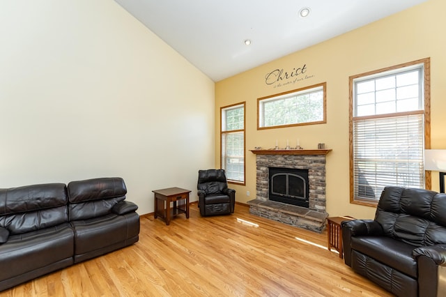 living room featuring wood finished floors, a fireplace, recessed lighting, and high vaulted ceiling