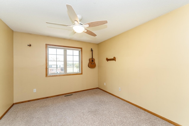 empty room featuring light carpet, baseboards, and a ceiling fan