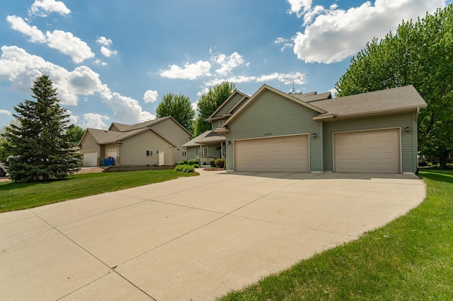 view of front facade with concrete driveway, an attached garage, and a front lawn