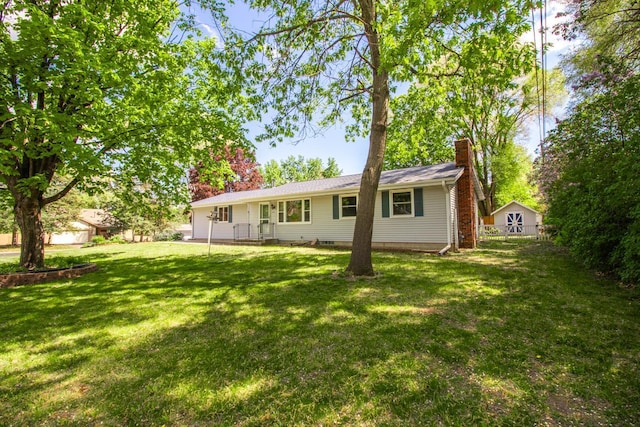 back of property with a chimney and a yard