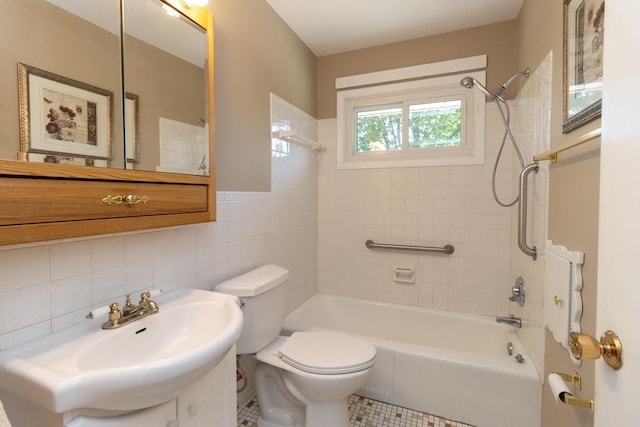 bathroom featuring tile walls, toilet, shower / washtub combination, tile patterned floors, and vanity