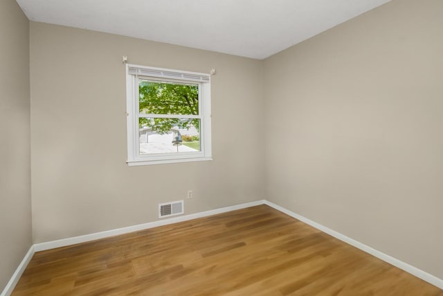 empty room with light wood-style floors and baseboards
