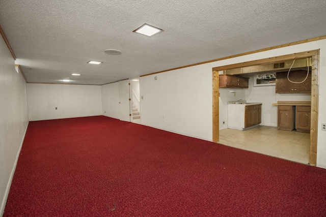 finished basement with a textured ceiling, carpet floors, and stairway