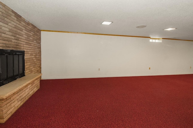 unfurnished living room featuring carpet flooring, a textured ceiling, and a fireplace