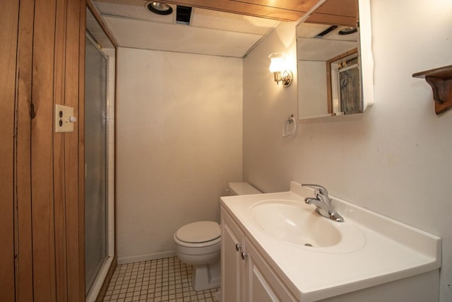 full bathroom featuring toilet, vanity, and a shower with shower door