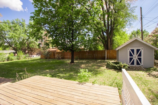 wooden deck featuring a shed and an outdoor structure