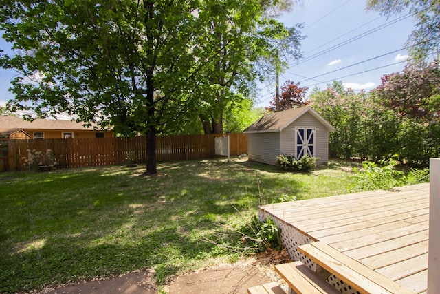 view of yard featuring a storage shed, an outdoor structure, and a wooden deck