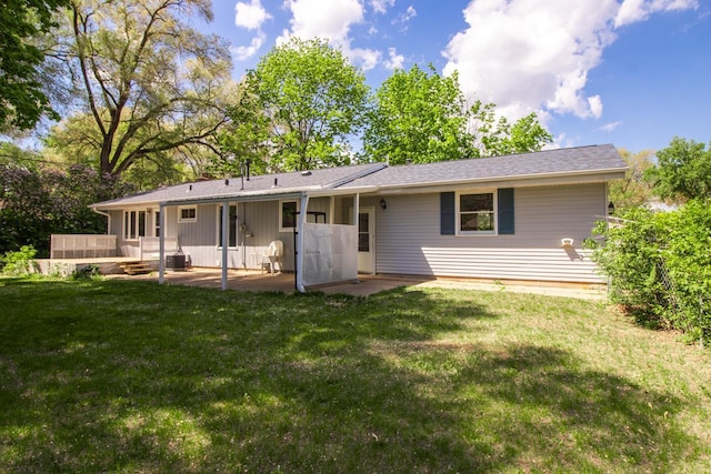 rear view of house with a patio and a yard