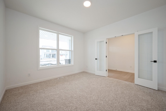 5713 Rathbun Way, Otsego, MN 55374 - unfurnished bedroom with french doors, light colored carpet, and baseboards