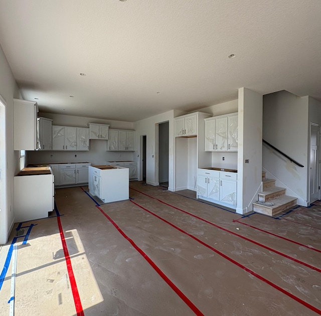 5713 Rathbun Way, Otsego, MN 55374 - kitchen with white cabinetry, a textured ceiling, and a center island