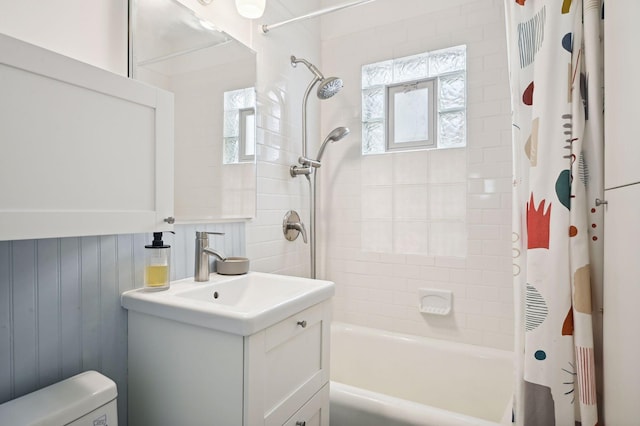 bathroom with shower / tub combo with curtain, toilet, and vanity
