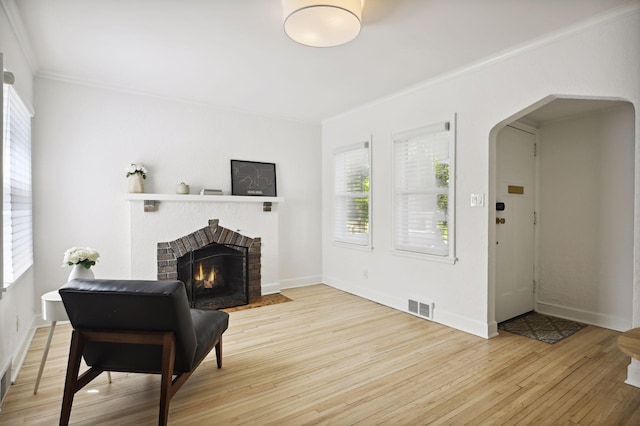 3937 Ewing Ave S, Minneapolis, MN 55410 - living room with ornamental molding, wood finished floors, arched walkways, plenty of natural light, and a fireplace
