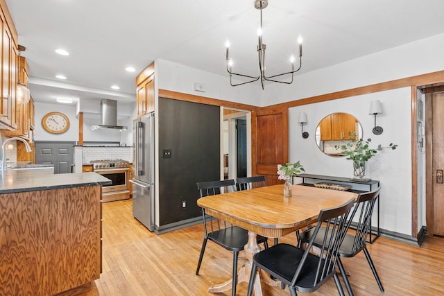 dining area featuring light wood-style floors, a chandelier, and recessed lighting