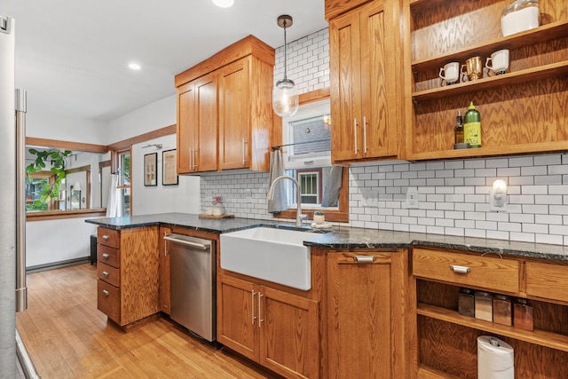kitchen featuring stainless steel dishwasher, a sink, light wood-style floors, open shelves, and recessed lighting