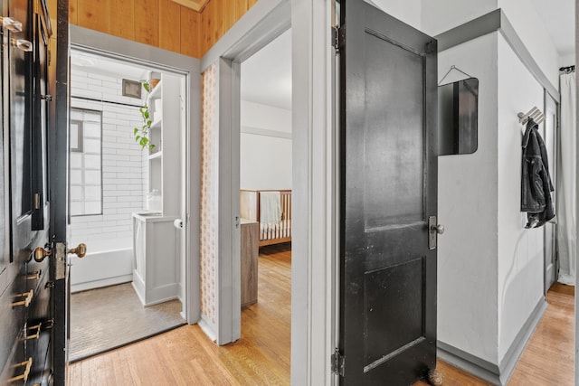 foyer entrance with light wood finished floors and baseboards