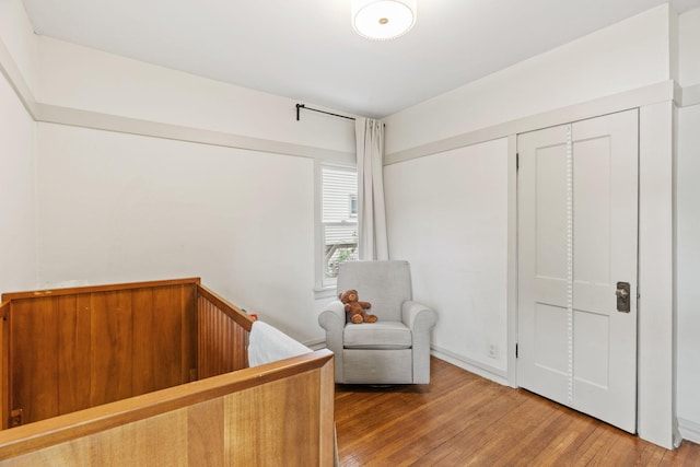 bedroom featuring wood finished floors and a closet