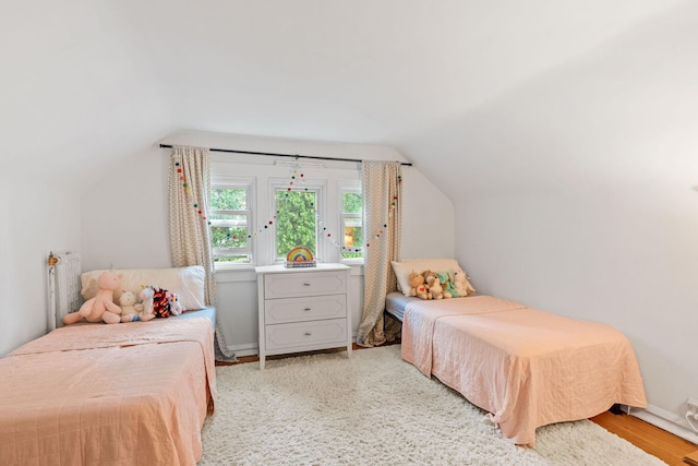 bedroom featuring vaulted ceiling and light wood-style floors