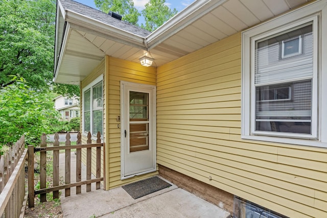 entrance to property with roof with shingles