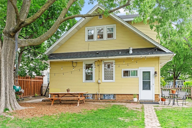 back of house featuring roof with shingles and a patio