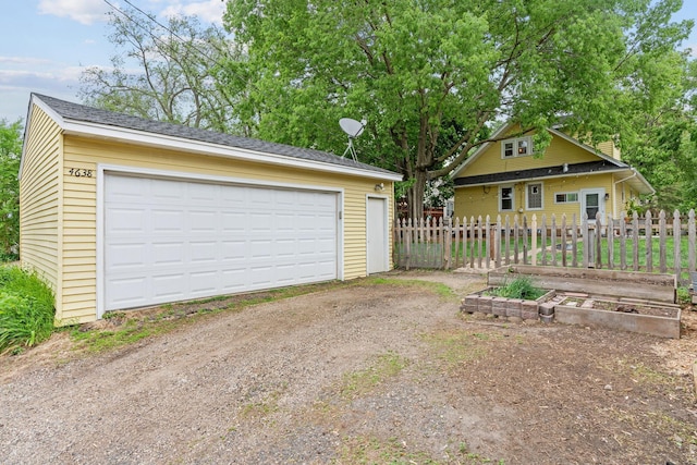 detached garage with a garden