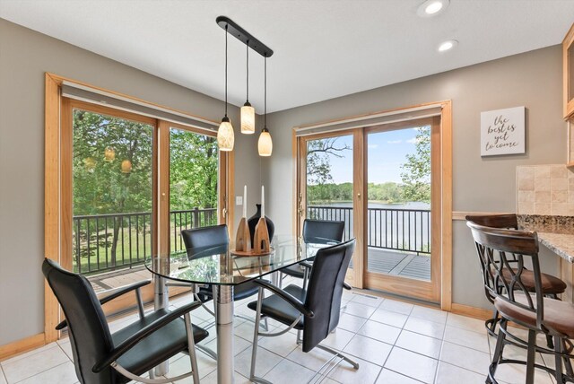 2270 Manning Trl N, Lake Elmo, MN 55042 - dining room with plenty of natural light, recessed lighting, a water view, and baseboards