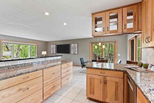 2270 Manning Trl N, Lake Elmo, MN 55042 - kitchen with light tile patterned floors, a peninsula, light stone counters, glass insert cabinets, and recessed lighting