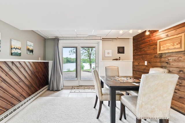 2270 Manning Trl N, Lake Elmo, MN 55042 - dining room with a baseboard radiator, wooden walls, light tile patterned floors, a water view, and wainscoting