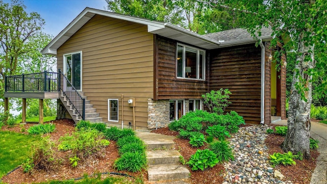2270 Manning Trl N, Lake Elmo, MN 55042 - view of front of home with stairway, a deck, and a shingled roof