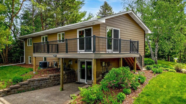 2270 Manning Trl N, Lake Elmo, MN 55042 - back of house featuring a wooden deck, stairs, a yard, cooling unit, and a patio area