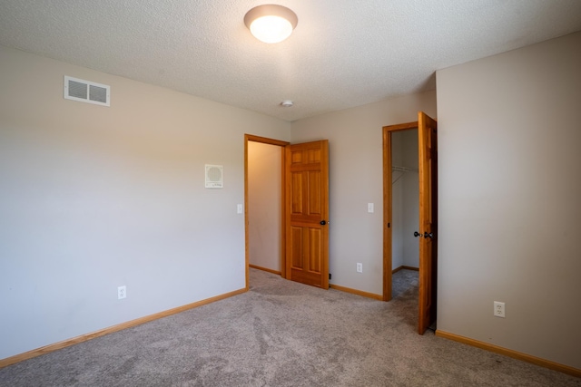13320 Cedar Ave, Apple Valley, MN 55124 - unfurnished bedroom with carpet, a spacious closet, and a textured ceiling