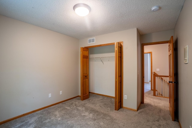 13320 Cedar Ave, Apple Valley, MN 55124 - unfurnished bedroom with light carpet, a textured ceiling, and a closet