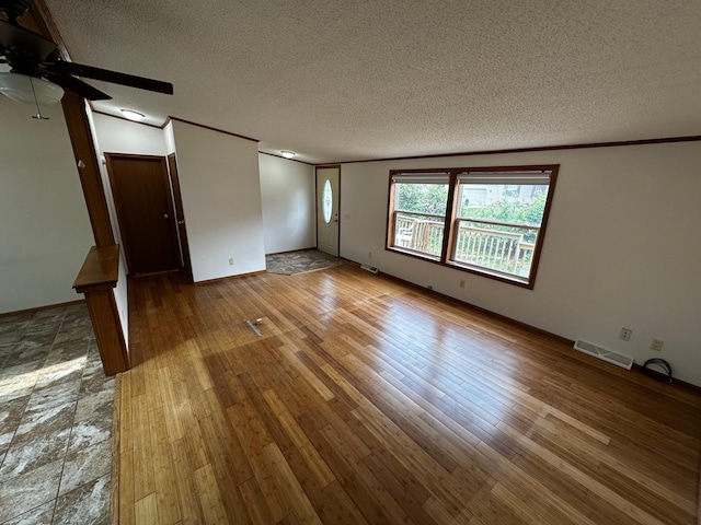 326 5th St NE, Crosby, MN 56441 - spare room with a textured ceiling, a ceiling fan, wood finished floors, and crown molding
