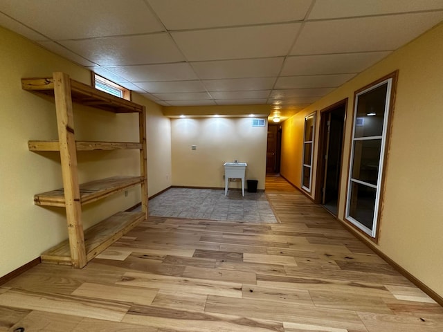 326 5th St NE, Crosby, MN 56441 - finished basement with light wood-style flooring, a drop ceiling, and baseboards