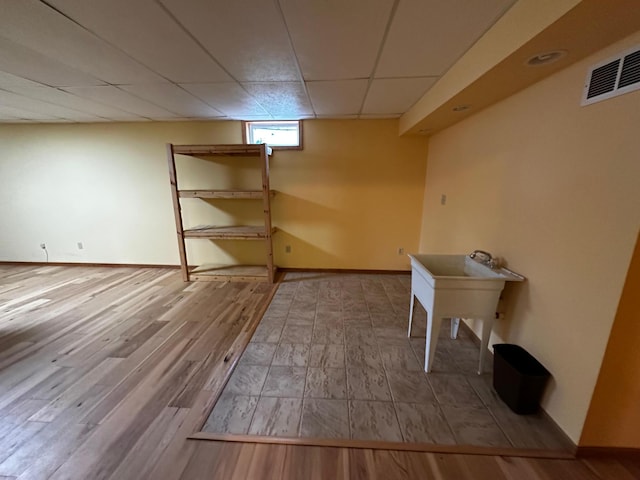 326 5th St NE, Crosby, MN 56441 - basement featuring a drop ceiling, wood finished floors, and baseboards