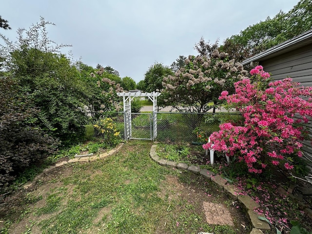 326 5th St NE, Crosby, MN 56441 - view of yard featuring a pergola and a gate