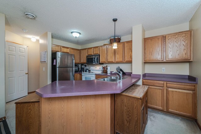 17366 River Birch Ln, Prior Lake, MN 55372 - kitchen featuring stainless steel appliances, a sink, brown cabinets, dark countertops, and a peninsula