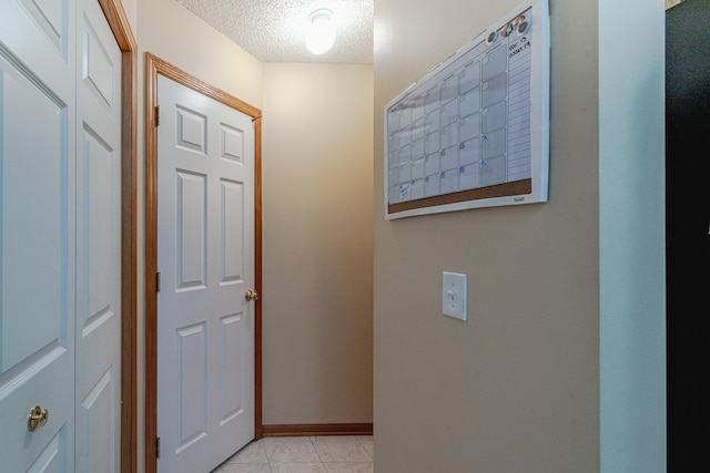 17366 River Birch Ln, Prior Lake, MN 55372 - corridor with a textured ceiling, light tile patterned floors, and baseboards