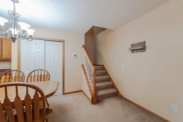 17366 River Birch Ln, Prior Lake, MN 55372 - dining area with light colored carpet, a chandelier, stairs, a textured ceiling, and baseboards