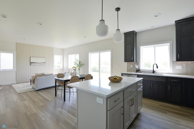 1182 Jill Dr W, West Fargo, ND 58078 - kitchen with a sink, light countertops, light wood-type flooring, tasteful backsplash, and recessed lighting