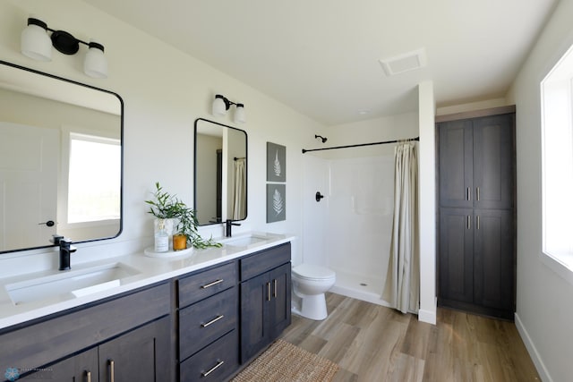 1182 Jill Dr W, West Fargo, ND 58078 - full bathroom featuring toilet, wood finished floors, and a shower with shower curtain