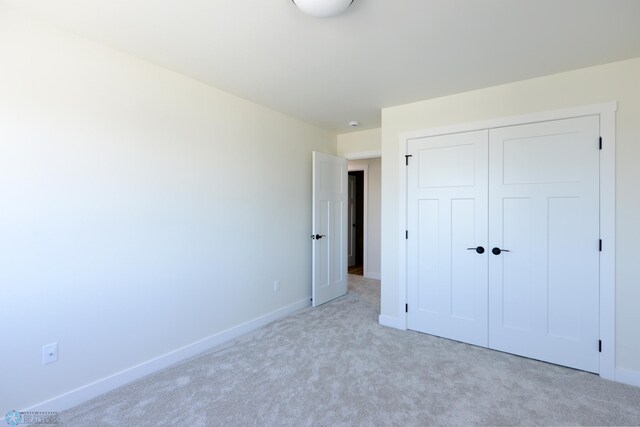 1182 Jill Dr W, West Fargo, ND 58078 - unfurnished bedroom featuring light colored carpet, baseboards, and a closet