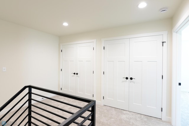 1182 Jill Dr W, West Fargo, ND 58078 - unfurnished bedroom with multiple closets, light carpet, recessed lighting, and baseboards