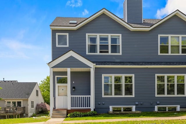 1715 Livingston Ave Unit A, West Saint Paul, MN 55118 - view of front of property featuring a shingled roof, a chimney, and covered porch