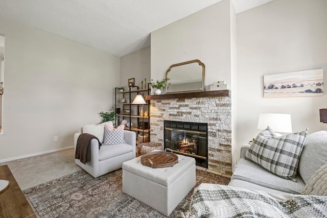 1715 Livingston Ave Unit A, West Saint Paul, MN 55118 - carpeted living area featuring a stone fireplace, baseboards, and lofted ceiling