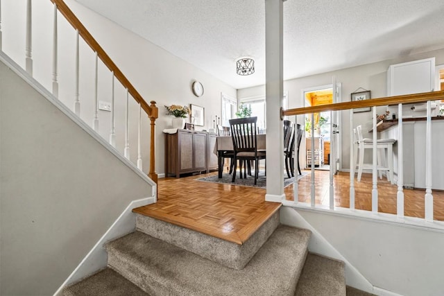 1715 Livingston Ave Unit A, West Saint Paul, MN 55118 - staircase with a textured ceiling and baseboards