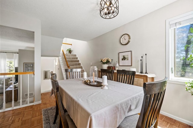 1715 Livingston Ave Unit A, West Saint Paul, MN 55118 - dining space with plenty of natural light, stairway, baseboards, and a textured ceiling