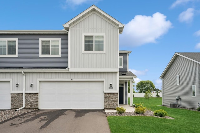 3248 Kady Ave NE, Saint Michael, MN 55376 - view of front of property featuring stone siding, board and batten siding, a front lawn, driveway, and an attached garage