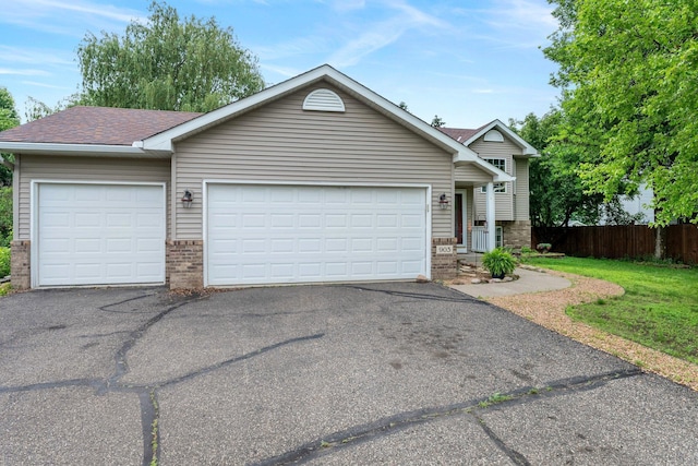 903 3rd Ave SW, Isanti, MN 55040 - view of front facade featuring brick siding, driveway, an attached garage, and roof with shingles